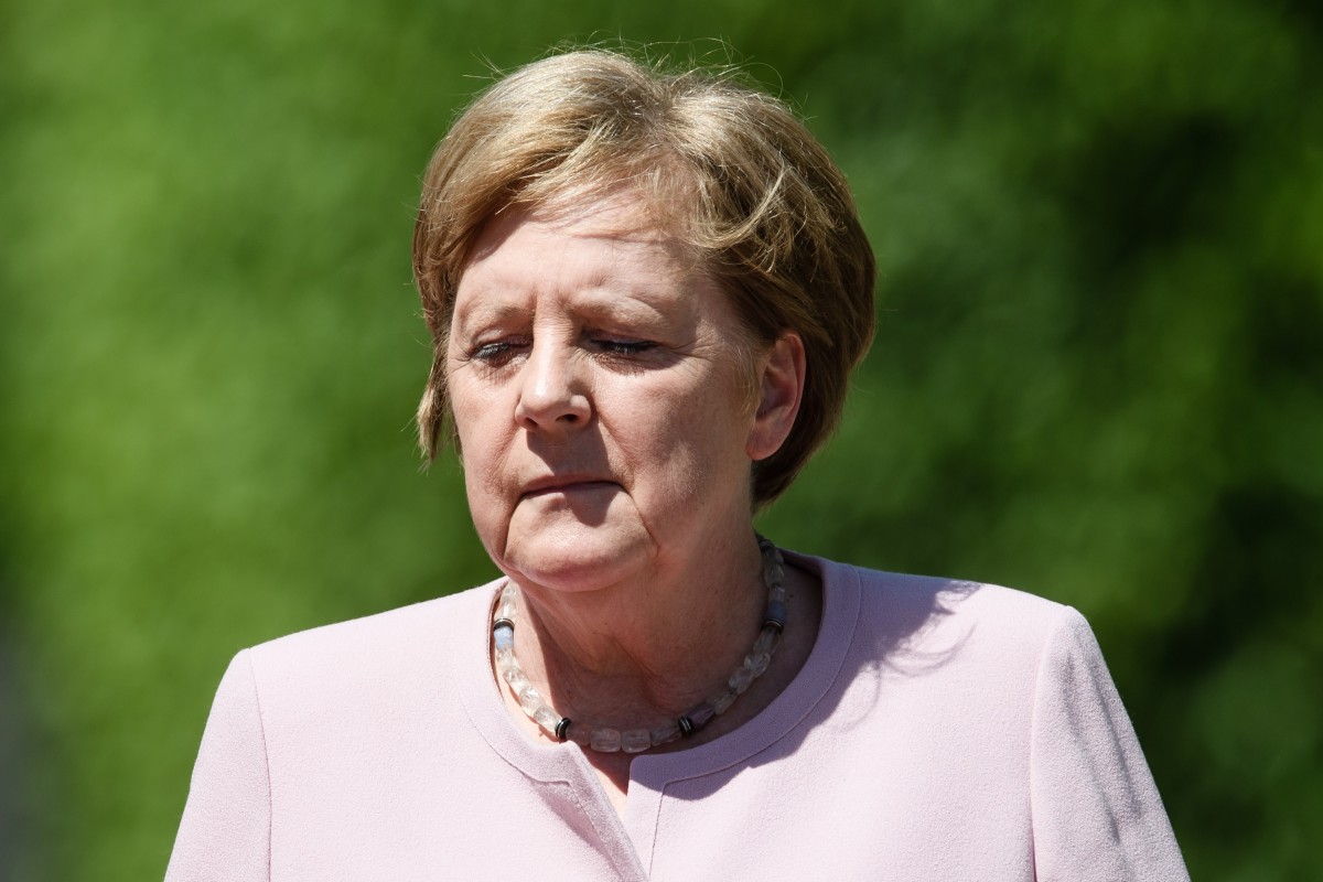 Angela Merkel says she is well despite suffering visible tremors